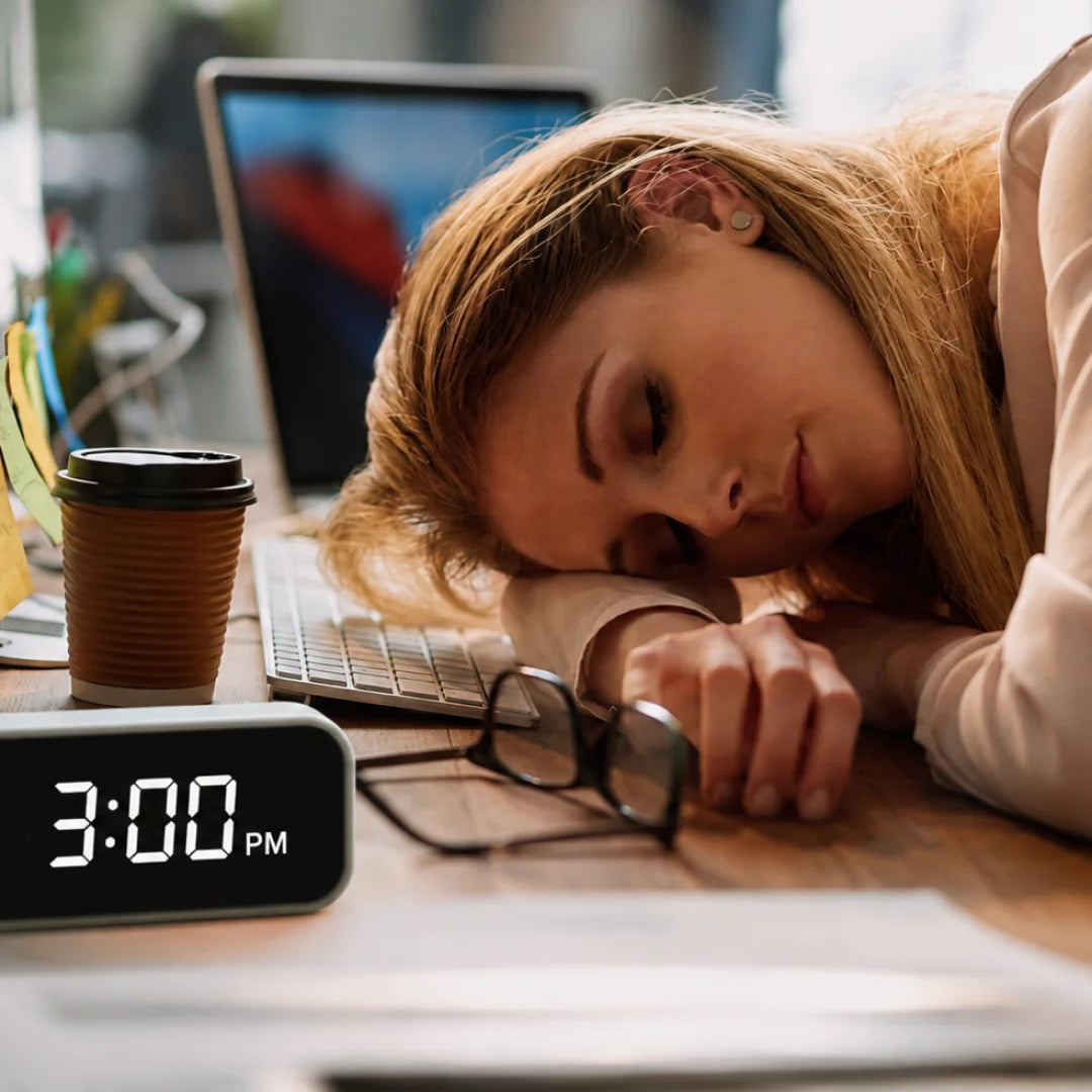 A woman taking a break from coffee at her desk